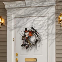 National Tree Company Artificial Skeleton's Halloween Wreath, Decorated With Branches, Orange And Black Trim, Berry Clusters, Assorted Leaves, 24 In